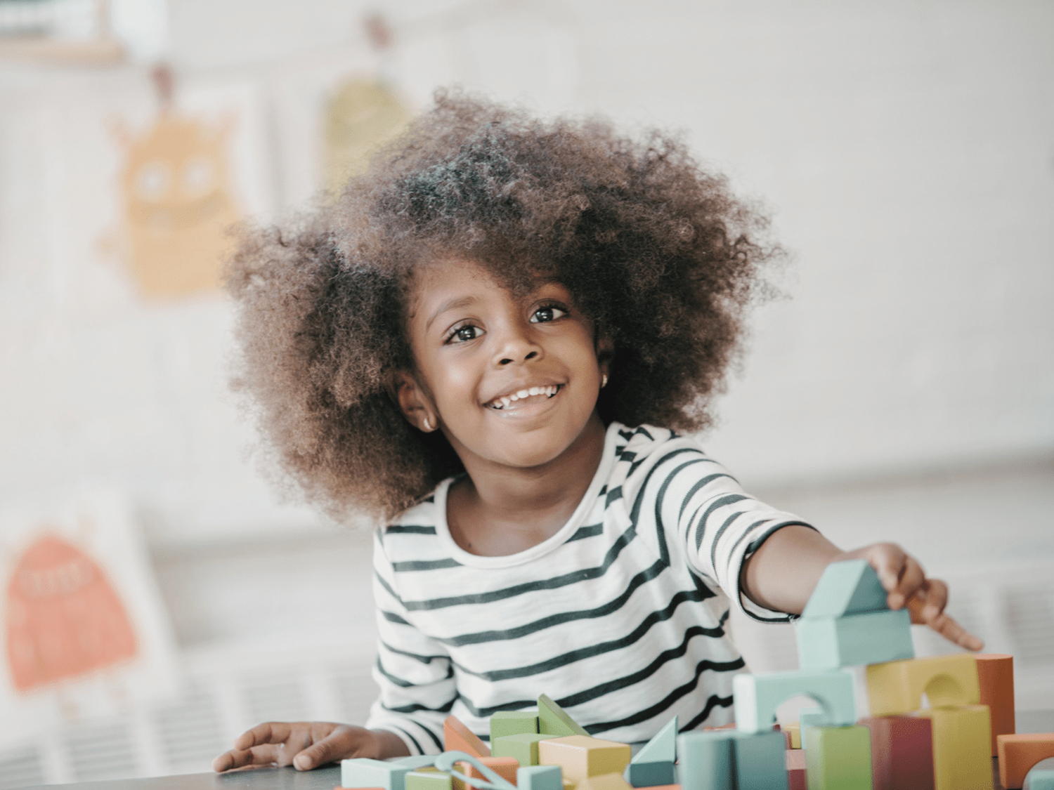 A child using building blocks to learn independently.