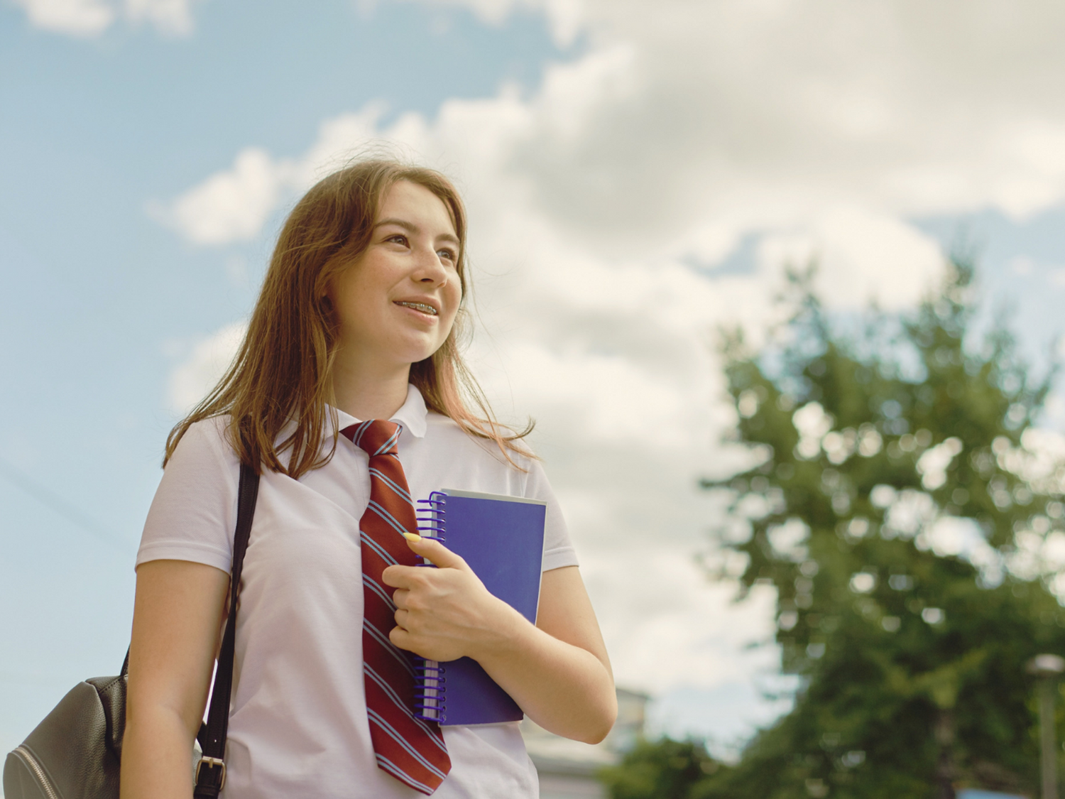 A student holding a notepad.