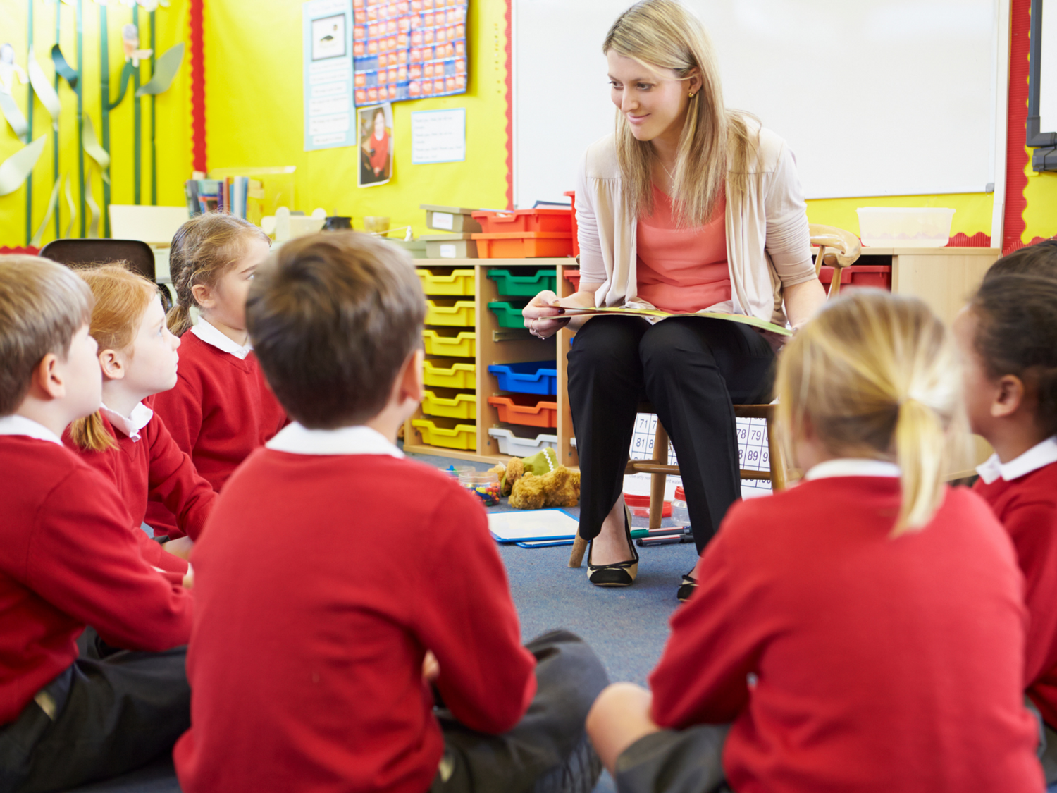 A teacher reading to a class of students