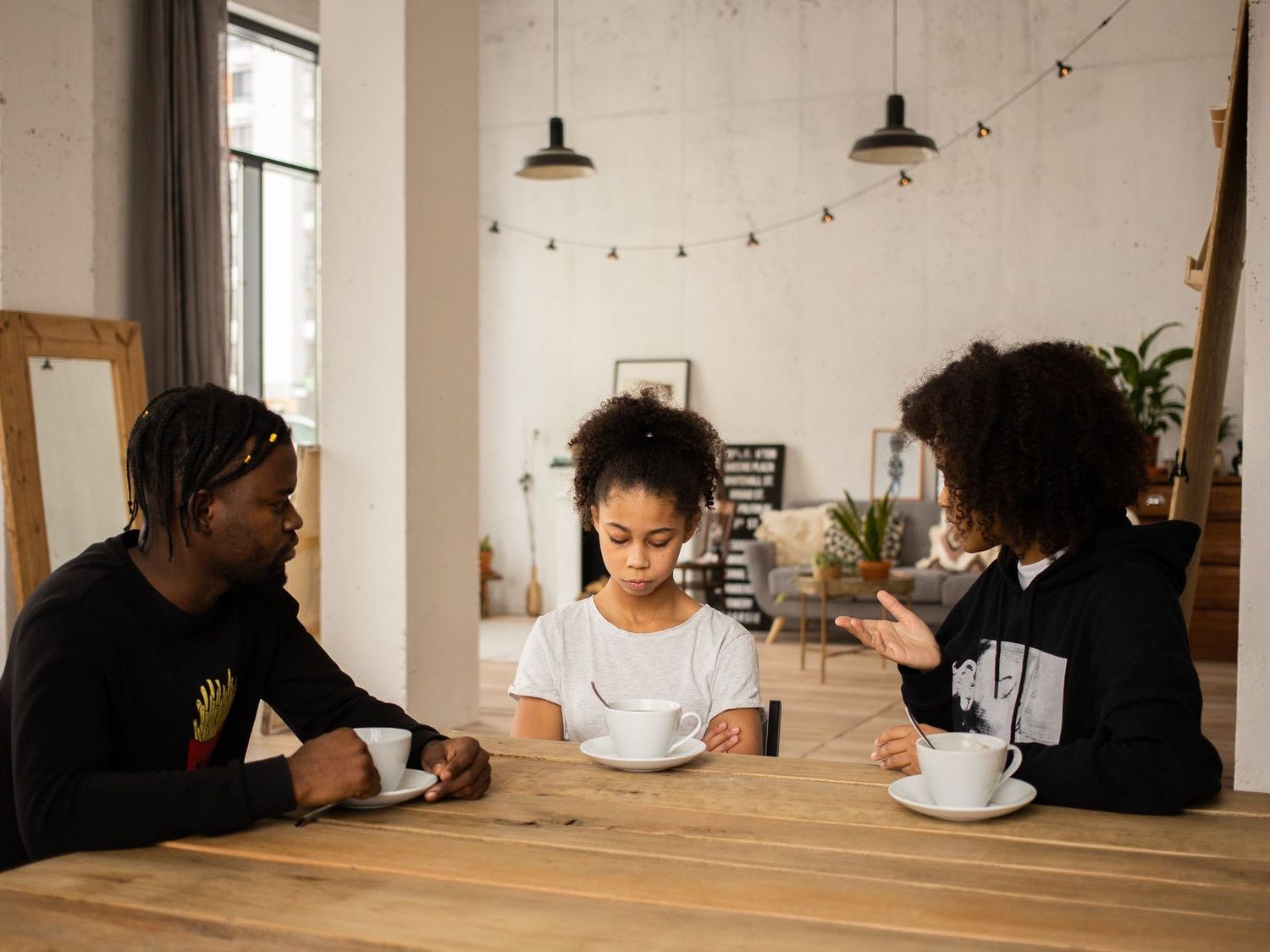 Two parents speaking to a child about emotional literacy