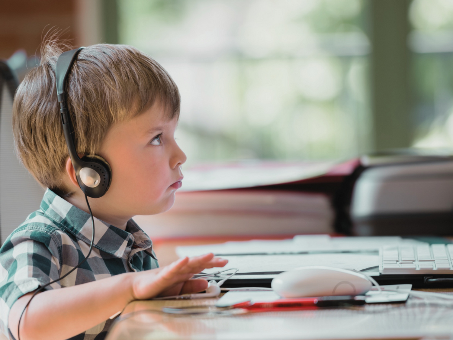 A child listening to a literacy podcast